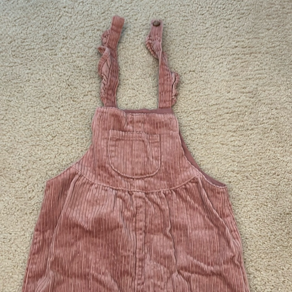 Corduroy overalls in blush pink.